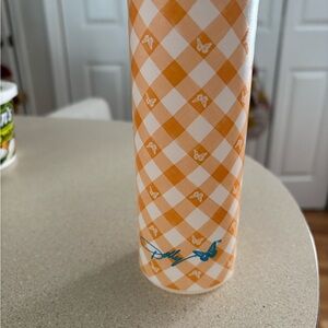 Orange Checkered Bottle with Butterfly Design by: Dolly Parton